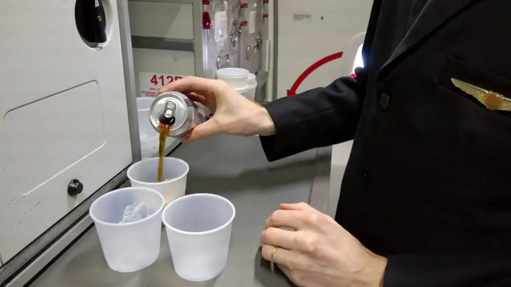 pouring diet coke in a plane