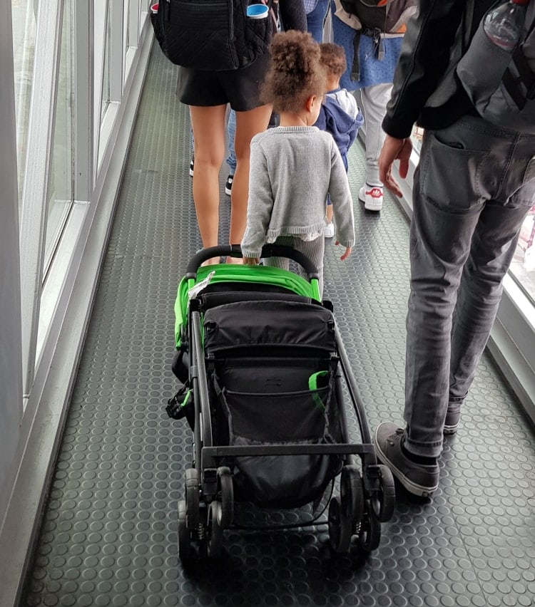 stroller carried by little girl in airport