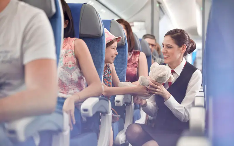 cabin crew attending a little girl