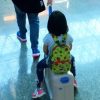 kid on rolling luggage